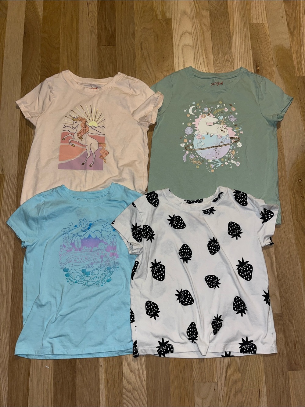 Bundle of four Cat & Jack shortsleeve  tees size S (6/7) unicorns, strawberries